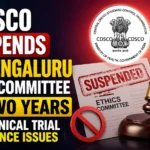 YouTube thumbnail showing CDSCO suspending the HCG Bengaluru Ethics Committee for two years over clinical trial compliance issues, featuring a gavel, suspension stamp, ethics committee document, CDSCO emblem, and HCG hospital building.