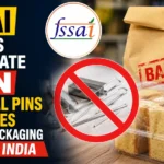 FSSAI announcement graphic showing a ban on metal pins and wires in food packaging, with food containers, packaging materials, and a prohibition symbol over metallic staples and pins.